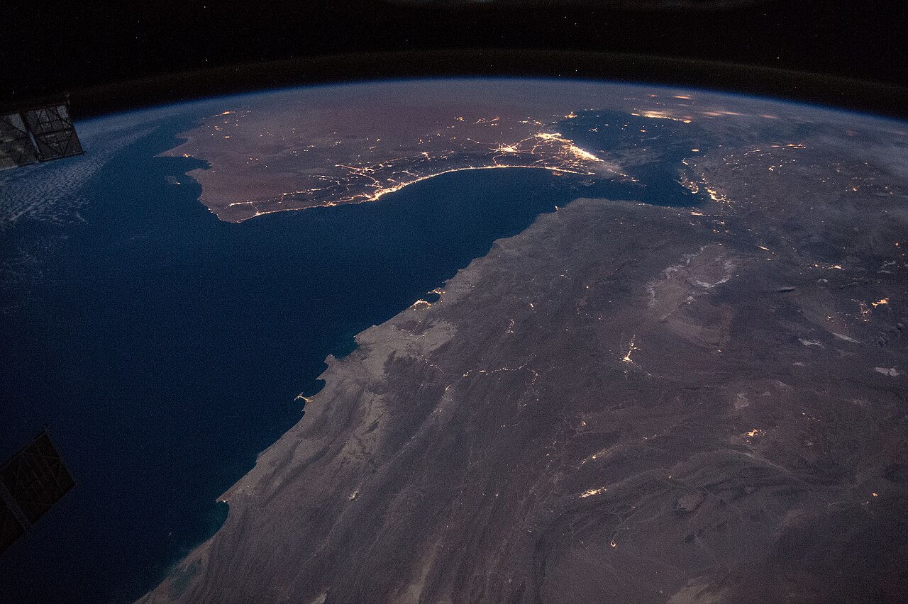 Night view from the International Space Station of city lights along the Gulf of Oman near the Strait of Hormuz